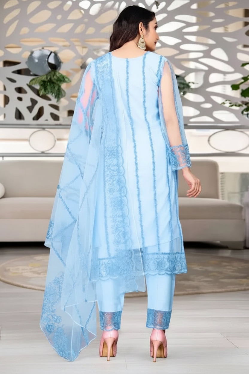 Woman wearing a light blue traditional outfit in an indoor setting